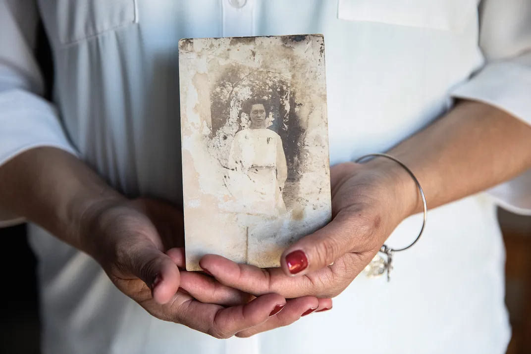 a women holds an old photograph