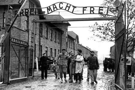 Soviet soldiers lead liberated prisoners out of Auschwitz in the winter of 1945.