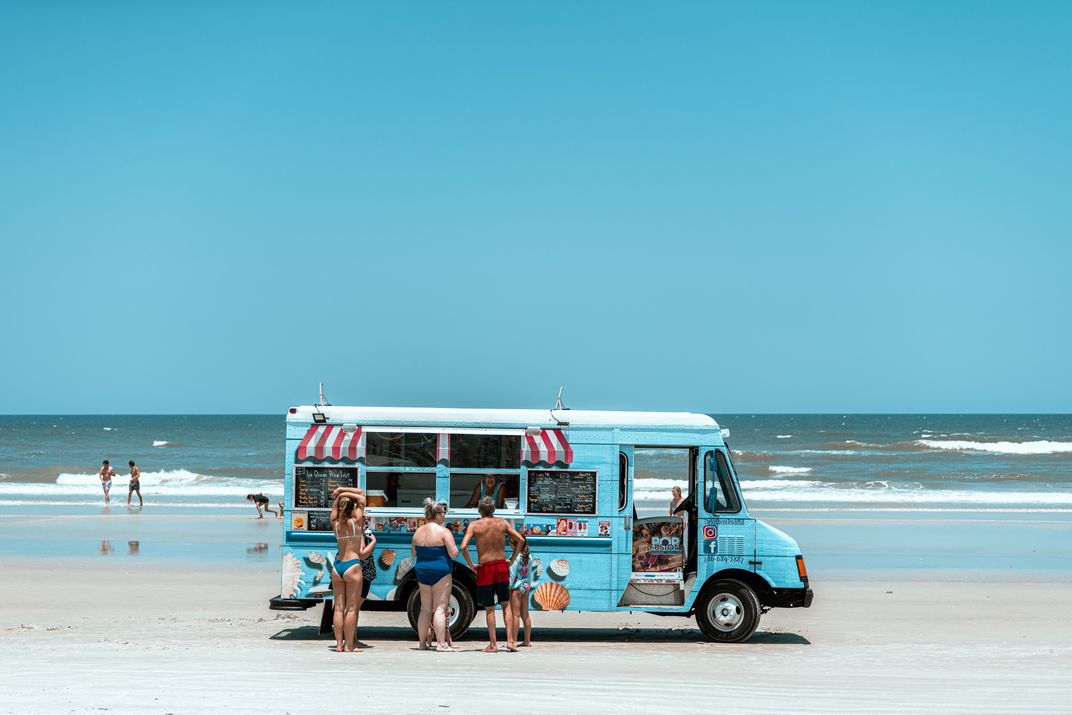 8 - An ice cream truck parks in the middle of New Smyrna Beach, playing its enticing lullaby, on a hot day.