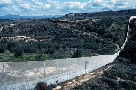 In a post-9/11 world, border walls between countries have become more common. But the science is severely lacking in our understanding of how they impact species and fragment ecosystems. Here, a continuous wire fence marks the border between the U.S. and Mexico near Tijuana.
