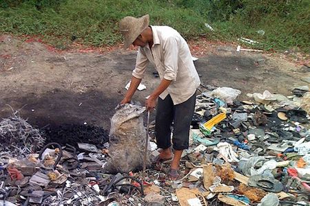 A man sorts through rubbish in Guiyu, the world’s largest center for electronic waste.