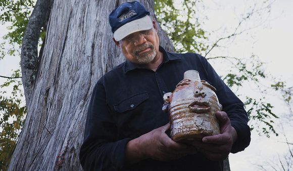 Jim McDowell holds his jug, “Emmett Till.” (Photo By Rimas Zailskas, courtesy of Asheville Made Magazine)
