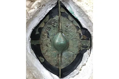 The shield was buried alongside a 2,000-year-old chariot drawn by two horses.