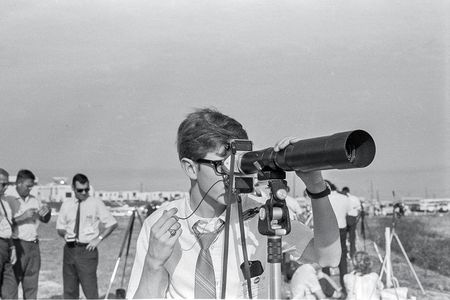 Using a borrowed 500mm lens, 18-year-old photojournalist Kevin L. Alexander, reluctantly wearing a necktie, takes aim at Kennedy Space Center launch pad 39A a few hours before the Saturn V’s history-making flight.
