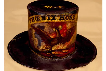 A fireman's hat dating to around 1860 was decorated for the Phoenix Hose Company of Philadelphia by David Bustill Bowser