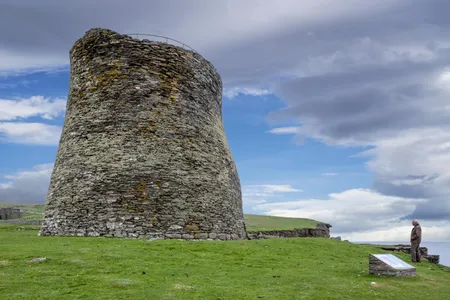 A tourist visits Mousa Broch, the tallest known Iron Age broch and one of Europe's best-preserved prehistoric buildings