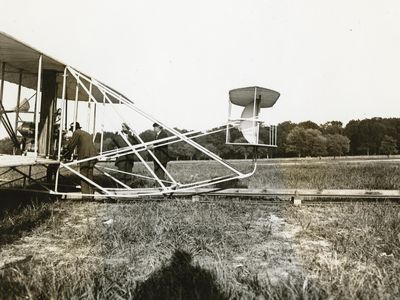 Charles Furnas at age 28 (bending over controls), when he helped the Wrights sell their Model A biplane to the Army at Fort Myer, Virginia.