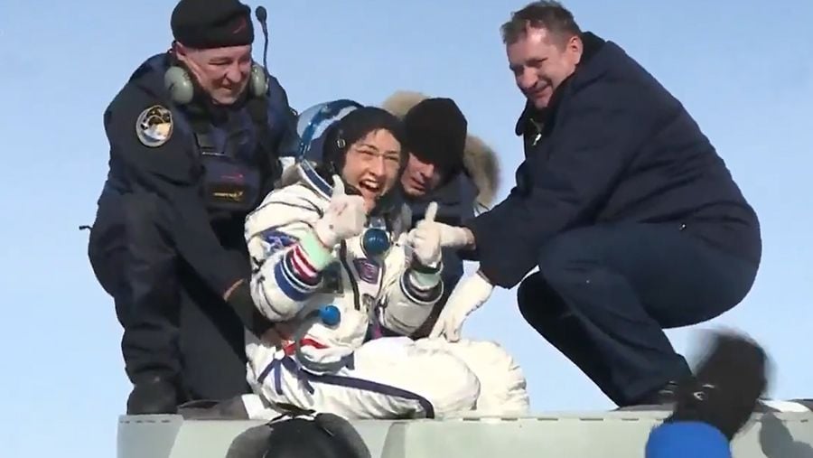 Christina Koch exits the Soyuz spacecraft, giving two thumbs up