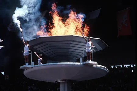South Koreans stand by the cauldron of the 1988 Summer Olympics