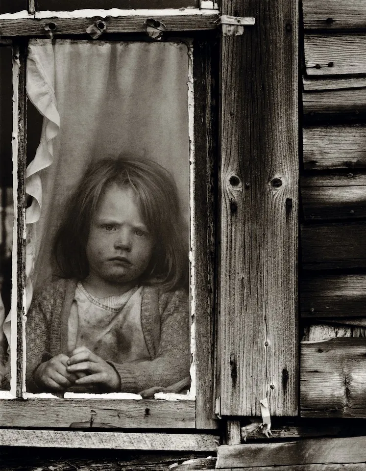 A young Walden resident, circa 1974, appears none too happy about being kept inside, or having her picture taken.