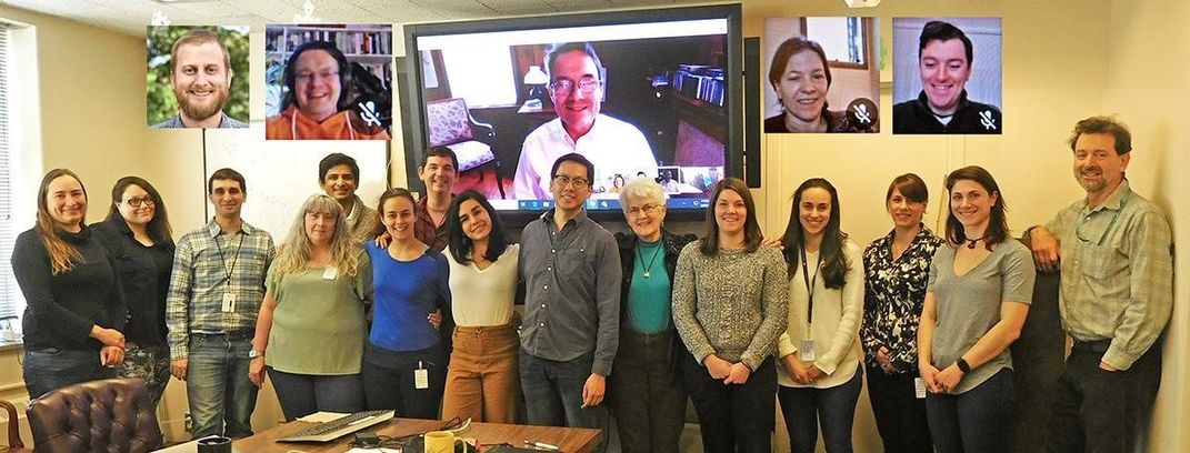 A group of people posing for a photo in a conference room.