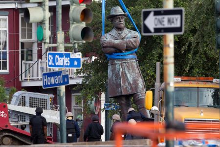A statue of Confederate General Robert E. Lee is lowered to a truck for removal Friday, May 19, 2017, from Lee Circle in New Orleans.