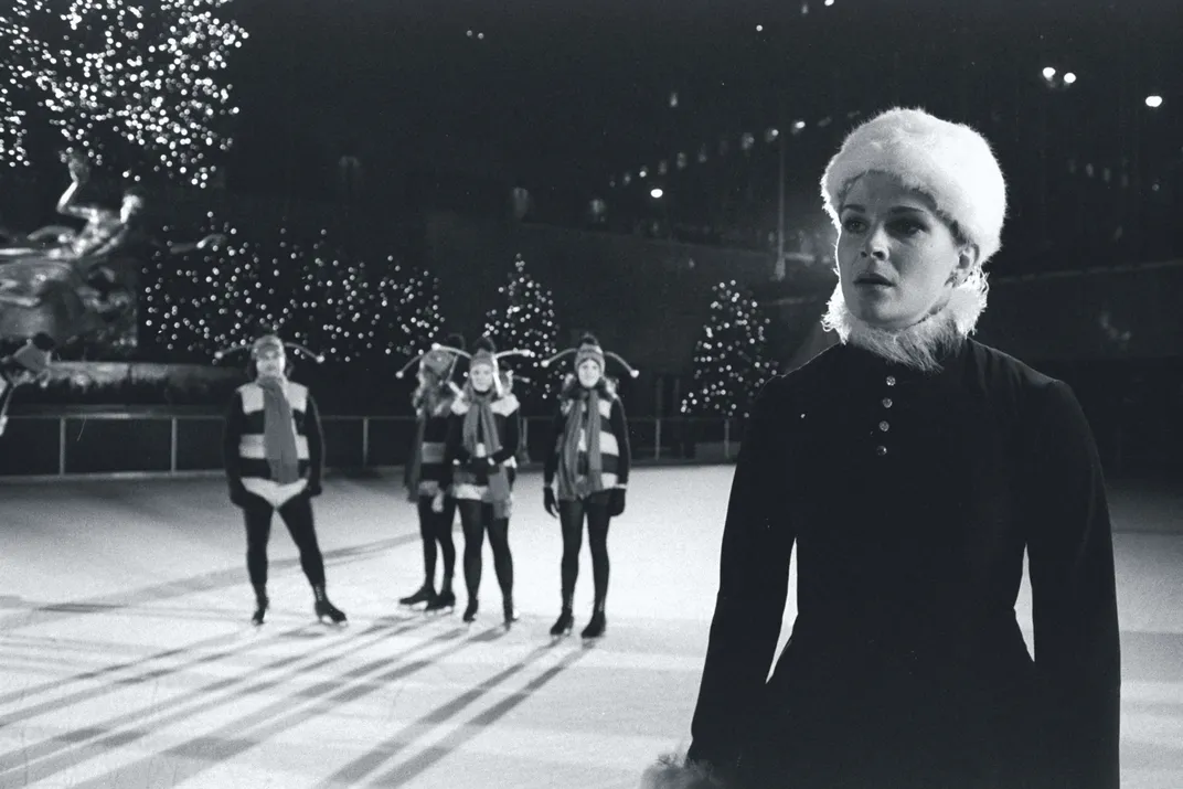 Candice Bergen (right foreground) dons a Santa's helper costume and skates for a "Saturday Night Live" skit.