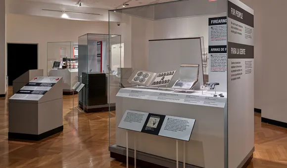 The interior of the Forensic Science on Trial exhibition. Several large cases with objects and text panels are visible.