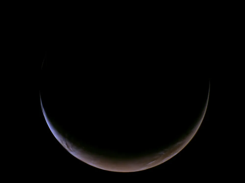Mars appears as a crescent pointed up, like a smile
