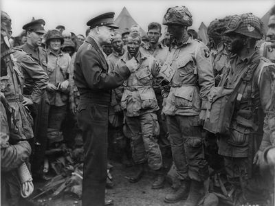 Gen. Dwight D. Eisenhower gives the order of the day: "Full victory—nothing else" to paratroopers in England, just before they board their airplanes to participate in the first assault in the invasion of the continent of Europe.