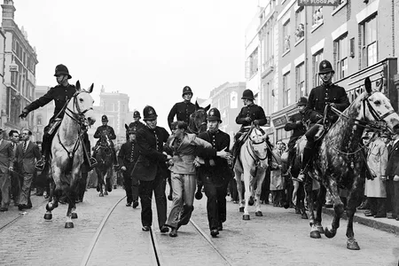 In this 1936 photo by Eddie Worth, an anti-fascist demonstrator is arrested during the Battle of Cable Street in London.