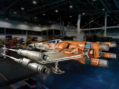 The blackened “laser-scarring” on the hull of this full-scale Star Wars prop is an example of the kind of camera-friendly damage conservators take pains to preserve.