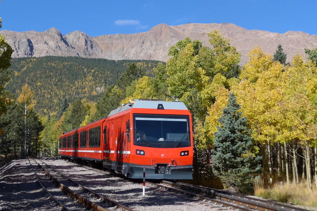 Red train car going up a mountain