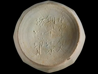 Ceramic box base with a Chinese inscription that mentions  a  place, Jianning Fu, which dates from AD 1162 to 1278.  From the Java Sea Shipwreck.