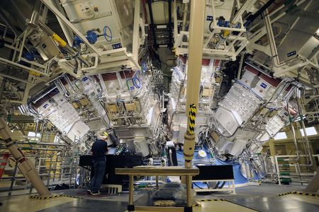 Engineers work outside the structure where the array of lasers at the National Ignition Facility at Lawrence Livermore Laboratory are focused.