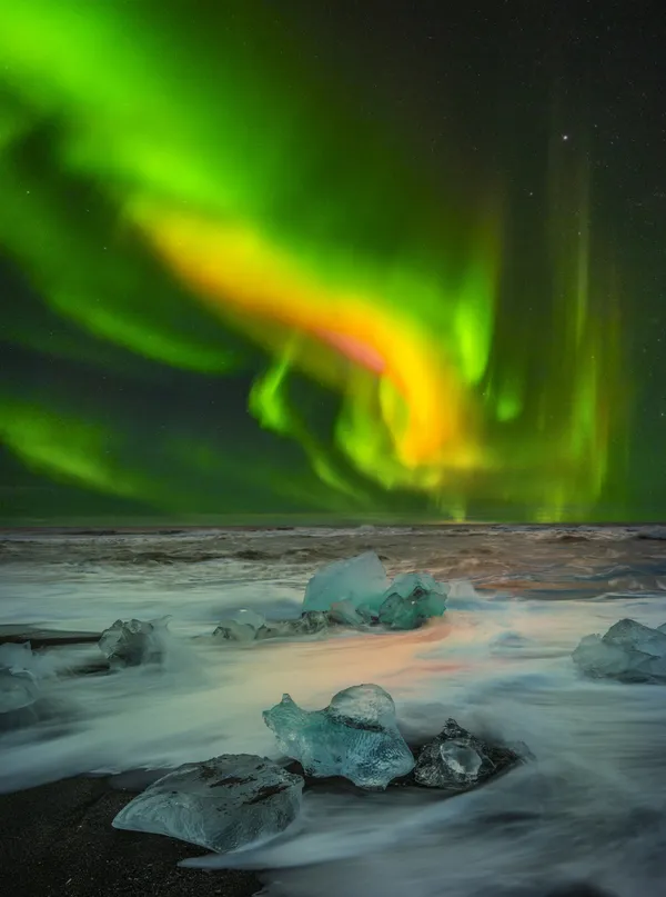 The Northern Lights over Diamond Beach in Iceland thumbnail