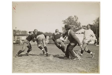 Photograph of John Steuart Curry sketching a football practice at the University of Wisconsin-Madison, 1936 or 1937 / unidentified photographer. John Steuart Curry and Curry family papers, 1848-1999. Archives of American Art, Smithsonian Institution.