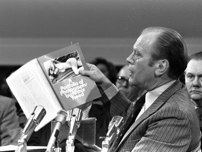 Vice President-designate Gerald Ford holds up a copy of Evergreen Review, a magazine which Ford described as obscene. One of Ford's charges against Douglas was that he had allowed an article he had written to be published in Evergreen.