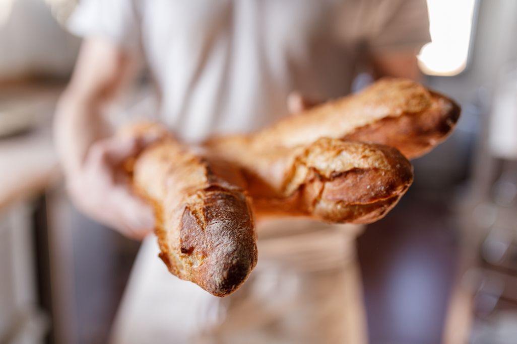 Baker holds baguettes