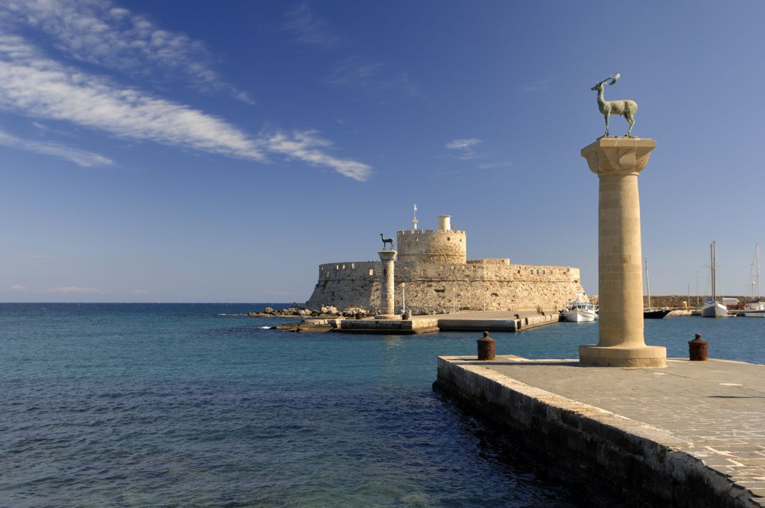 Historic entrance to the harbor in Rhodes, Greece