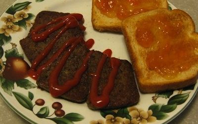 Snowpocalypse scrapple with ketchup, served with a side of toast.