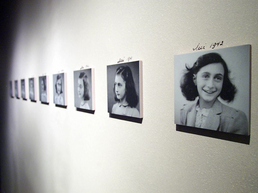 Photos of Anne Frank on a wall