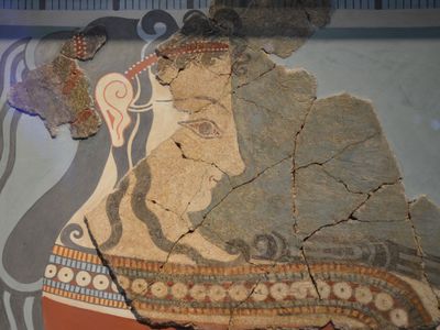 A fragmented painting of a woman bearing offerings, from the Mycenaean palace at Tiryns. 
