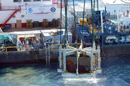 The revolving gun turret from “Ironclad” ship USS Monitor is lifted from the ocean floor. An NEH grant will go toward a conservation initiative to preserve objects from the Civil War-era ship.
