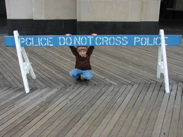 Kid under police sign thumbnail