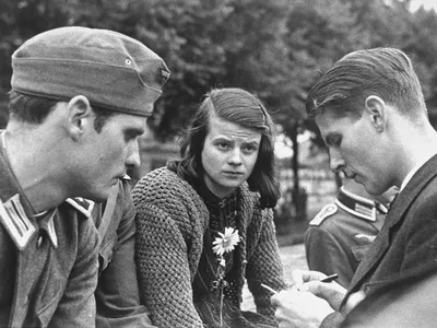 Sophie Scholl (center) bids farewell to her brother Hans (left) and friend Christoph Probst (right) before their departure for the Eastern Front in July 1942.