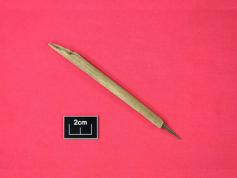 medieval ink pen made of bone and copper