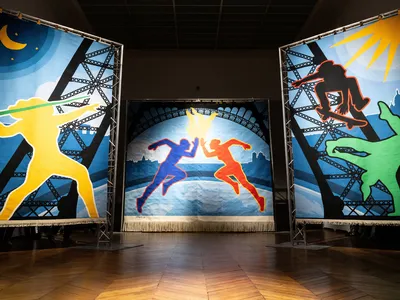 The three-panel artwork depicts a javelin thrower, a skateboarder and a break dancer.