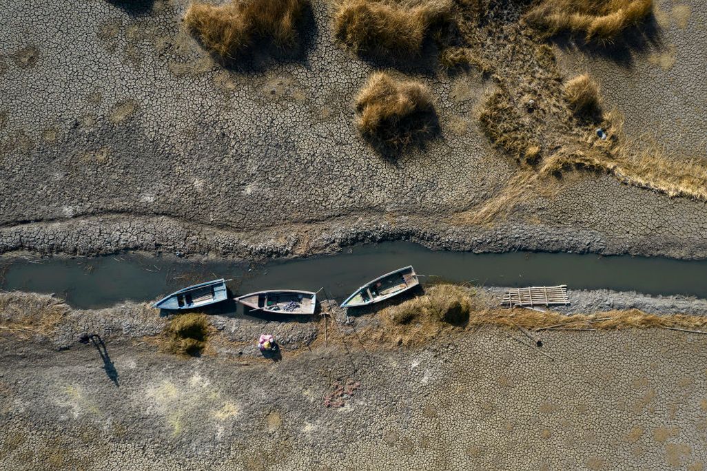 Dried up river with three boats on the bank