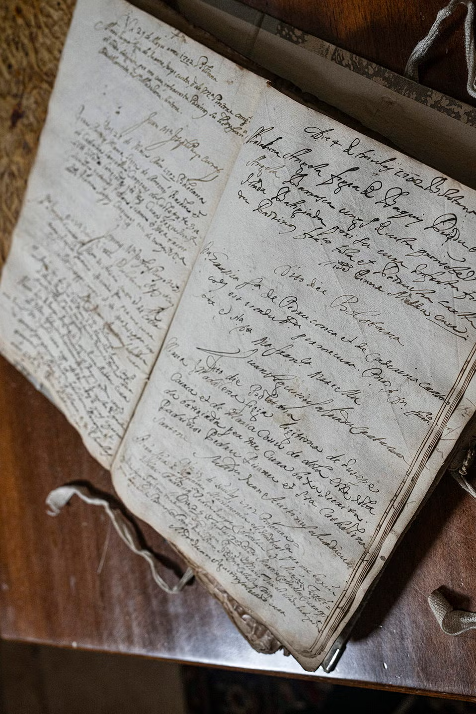A book with handwriting open on a table