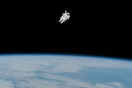 Bruce McCandless floats freely in space with Earth 170 miles beneath him.