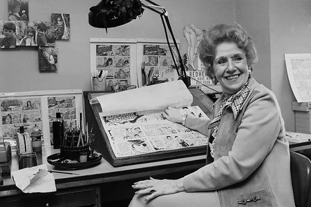 Dale Messick, creator of the comic strip "Brenda Starr," looks up from some of her strips in her studio in her Chicago apartment in 1975.