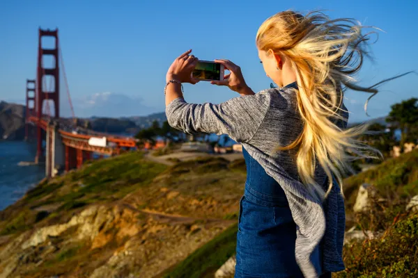 Strong wind at the Golden Gate Bridge blowing into her blond hair thumbnail