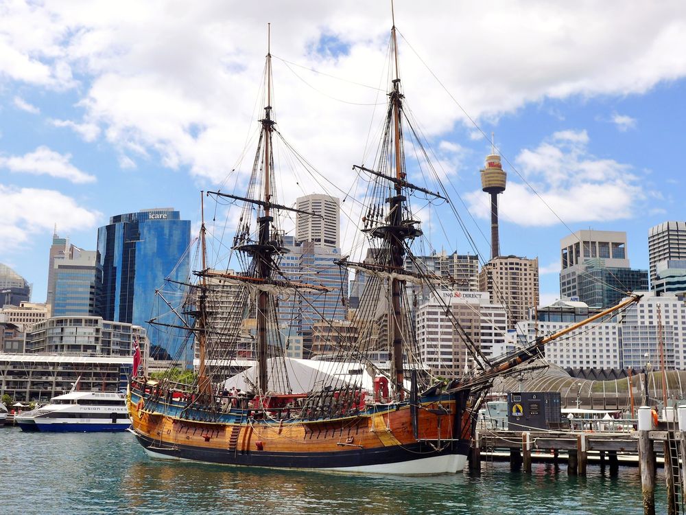 giant wooden three-mast ship parked in harbor at Sydney.