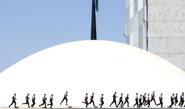 Policemen run across the National Congress in Braslia during demonstration against corruption. thumbnail