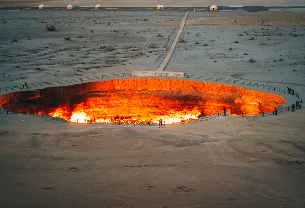 Giant crater pit filled with hot molten earth in middle of desert