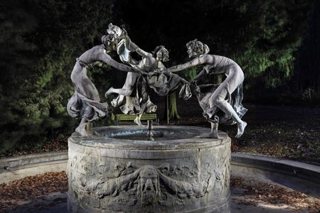 With fingers intertwined and mouths gleefully thrown open, the three maidens dance around the Art Nouveau sculpture by Walter Schott.