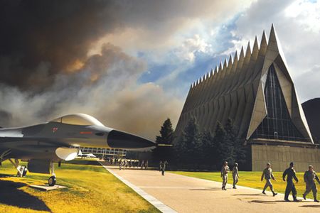 An ominous cloud of smoke from the Waldo Canyon Fire rises from the south behind the Air Force Academy's Cadet Chapel as cadets head for a briefing on evacuation procedures June 27, 2012. The Academy evacuated more than 600 families and 110 dormitory residents from the base the evening of June 27. (U.S. Air Force photo/Carol Lawrence)
