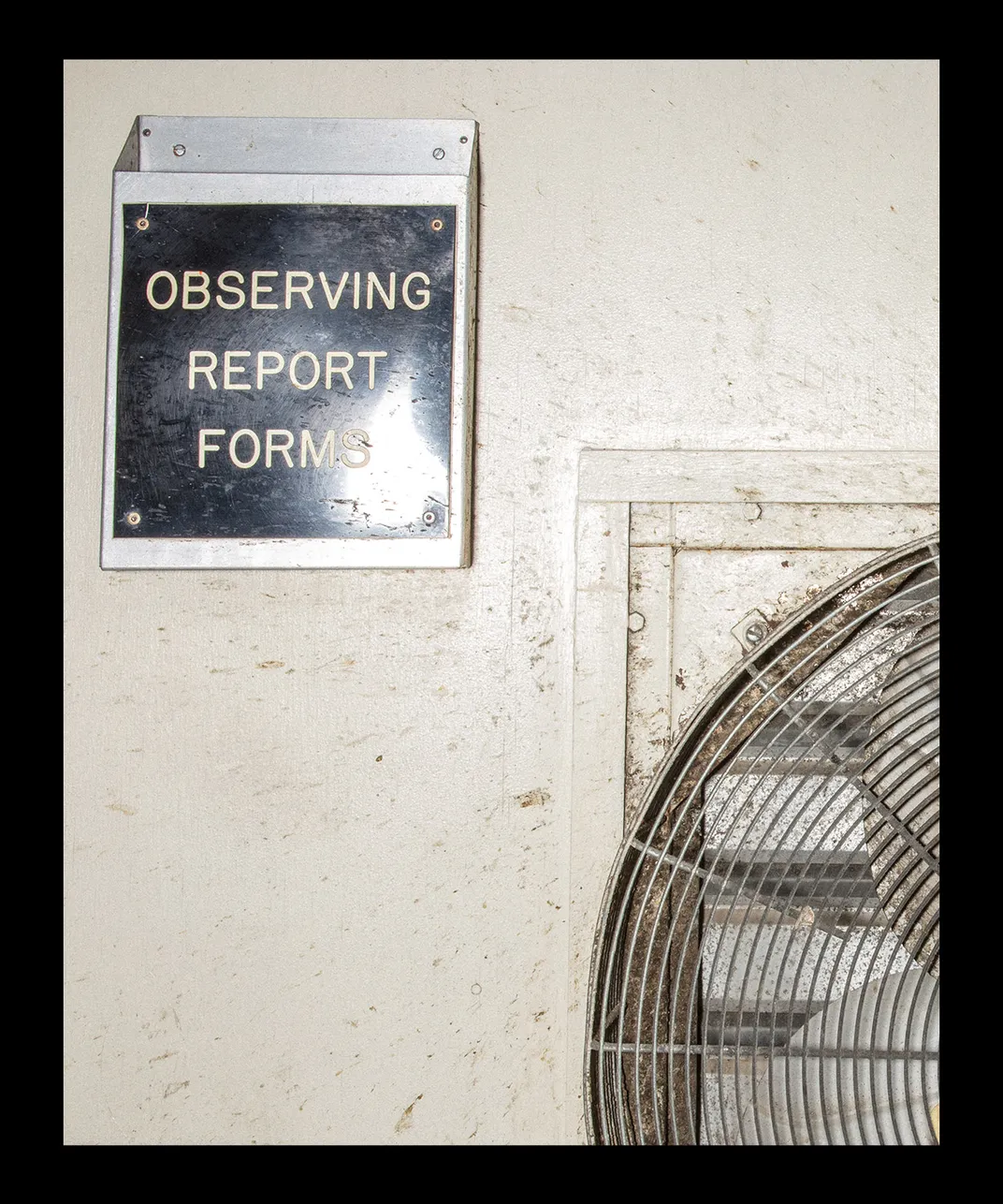 a physical inbox mounted to the wall reads "observing report forms"