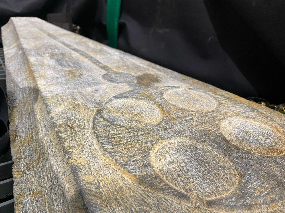 Close-up shot of carved cross on grave slab